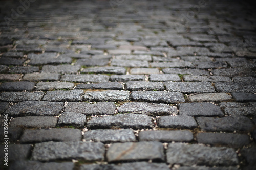 blur image of perspective old cobblestone pavement. background, texture.