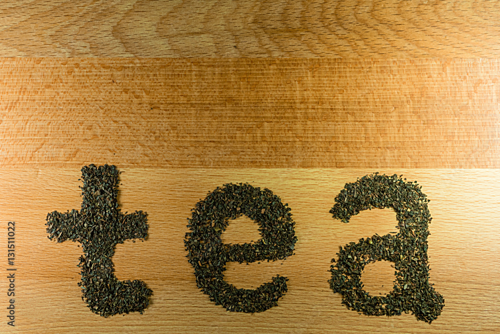Foto Stock Word tea is laid out on a lightbrown wooden Board small