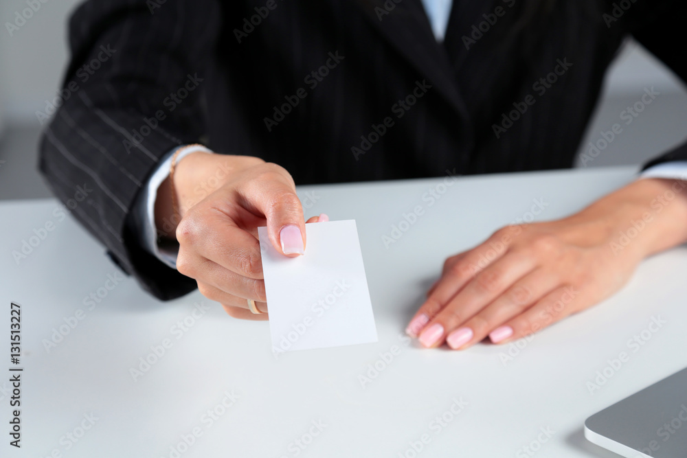 Businesswoman holding blank visit card ,sitting on the desk Businesswoman holding blank visit card ,sitting on the desk