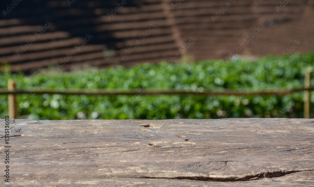 Fototapeta premium wooden deck table with strawberry field