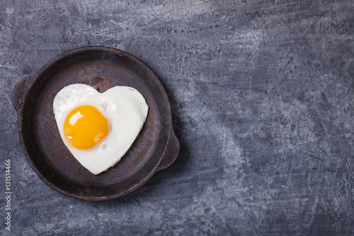 Fried egg in heart shape on the pan.Holiday Valentine's Day.Breakfast. Healthy Food.selective focus.