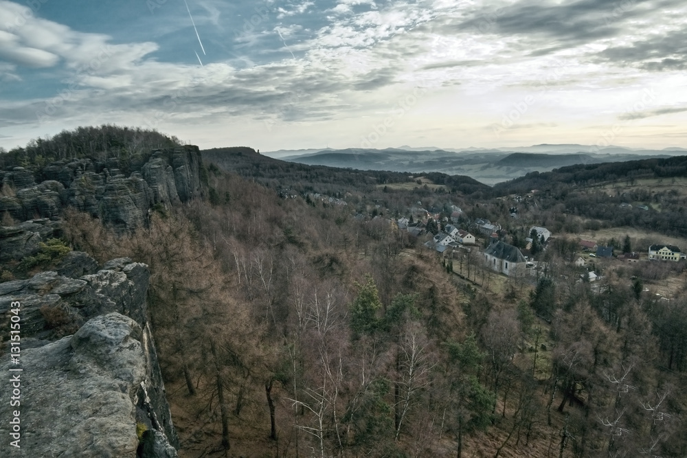 view from rocks to village Tisa in czech Krusne hory mountains in winter without snow