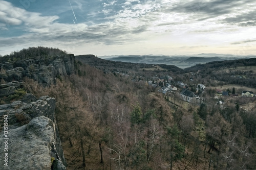 view from rocks to village Tisa in czech Krusne hory mountains in winter without snow