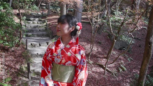 Japanese girl wearing kimono walking through temples gardens steadycam shot 
