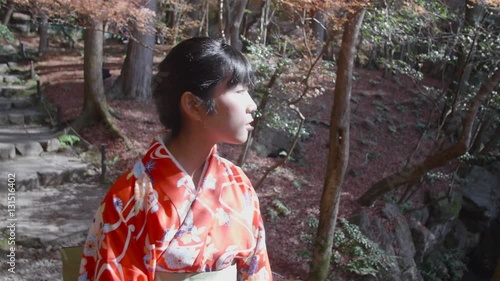 Japanese girl walking through temple gardens steadycam shot