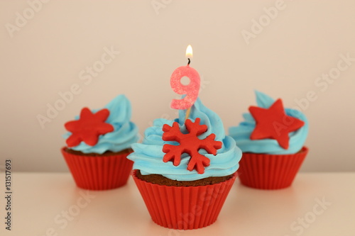 number 9 candle on red cupcake