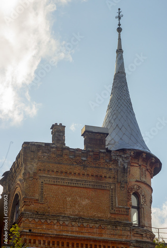 Old brick circular tower with a peaked roof