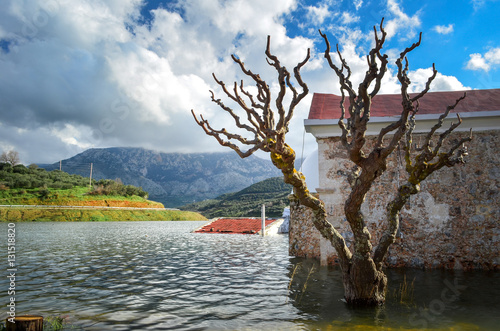 Sfentyli is an abandoned village which is sinking every winter when the dam of Aposelemi gets filled with water.   photo