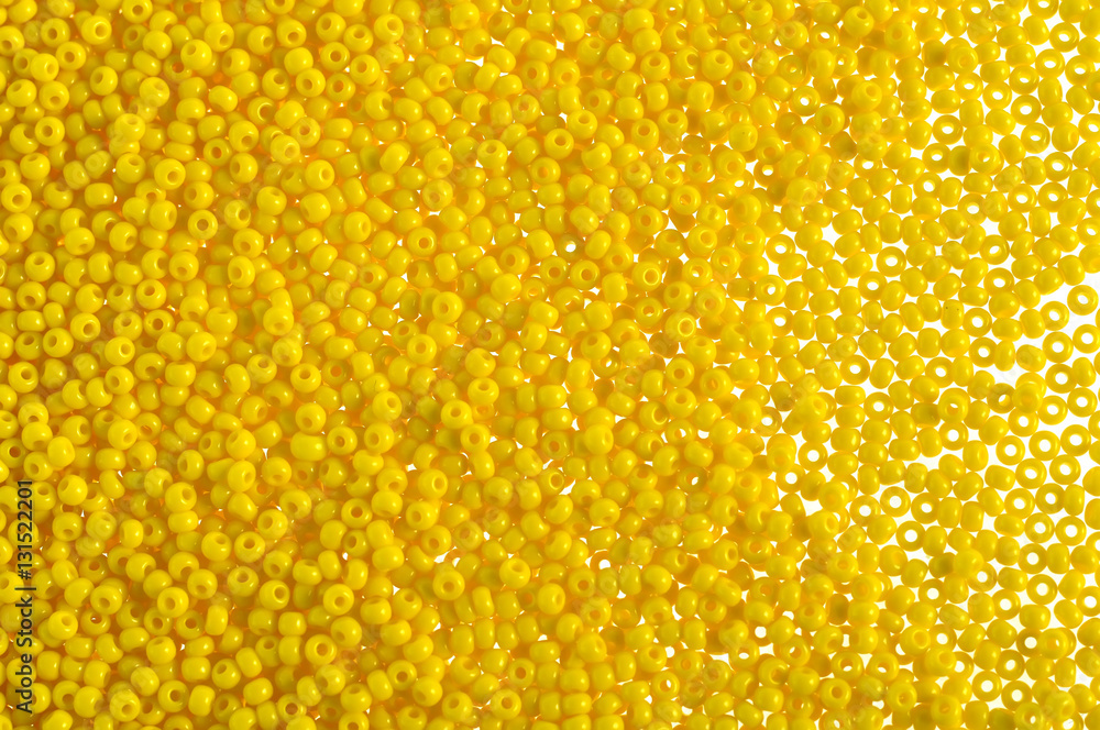 Fototapeta premium Yellow glass beads background - closeup beads texture
