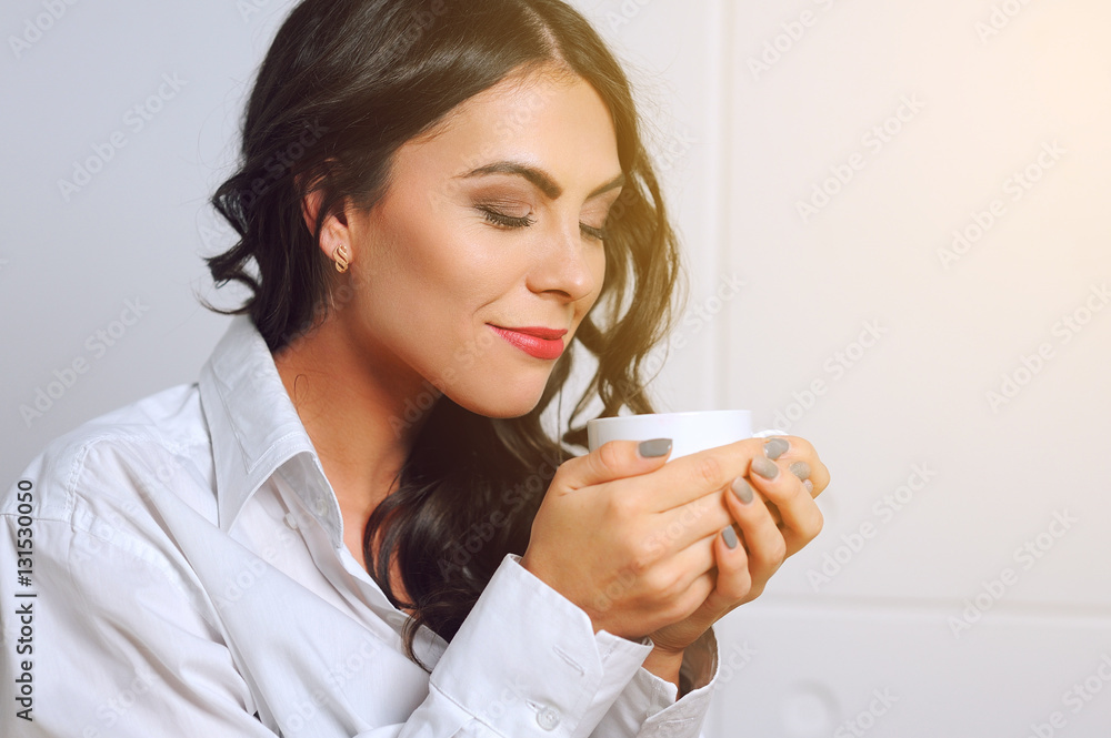 Girl in an armchair with a cup of coffee in the morning Girl in an armchair with a cup of coffee in the morning
