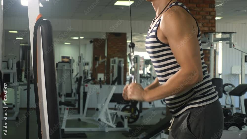 Strong athlete man doing exercise on triceps Strong athlete man doing exercise on triceps