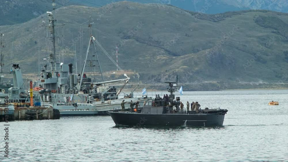 Argentina Navy Boat with Sailors Arriving at Base in Ushuaia with Various Navy War Vessels Docked at the Southernmost Part of South America Argentina Navy Boat with Sailors Arriving at Base in Ushuaia with Various Navy War Vessels Docked at the Southernmost Part of South America