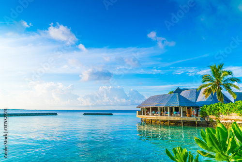 Fotografia Beautiful water villas in tropical Maldives island at the sunris