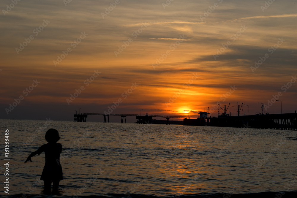 Fototapeta premium People walk ocean beach sunset