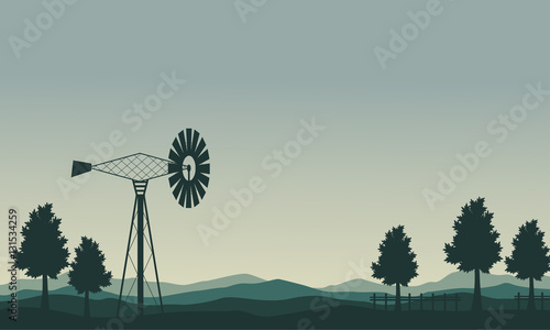 Silhouette of windmill and tree scenery