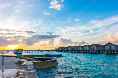 Fototapeta Naklejka Na Ścianę i Meble -  Beautiful sunrise with  water villas  in tropical Maldives islan