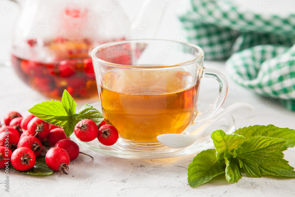 tea with a hawthorn and mint in a cup on a table, selective focus tea with a hawthorn and mint in a cup on a table, selective focus
