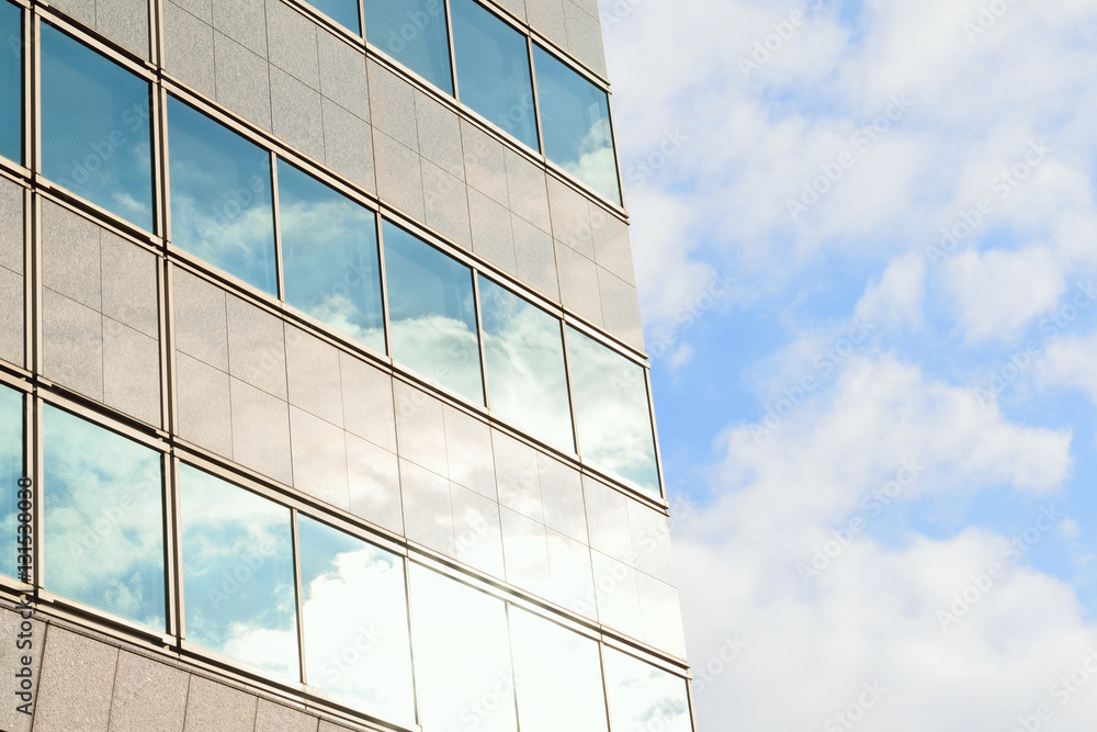 Modern building with clouds & sunshine in horizontal frame Modern building with clouds & sunshine in horizontal frame