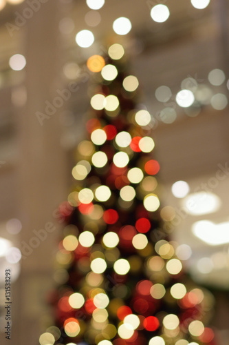 Holiday background - Large Christmas tree blurred lights in vertical frame