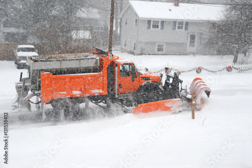 snowplow removing snow in the street after blizzard