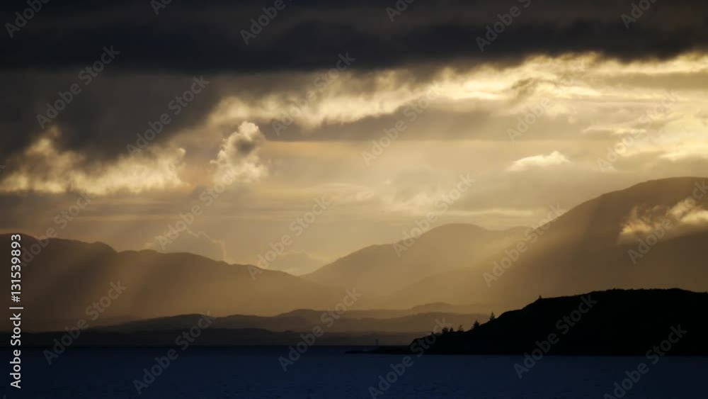 Sun beams to mountains during sunset at Isle of Skye Scotland, UK
Sun beams to mountains during sunset at Isle of Skye Scotland, UK
