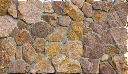 red granite, cobblestone wall, close-up texture