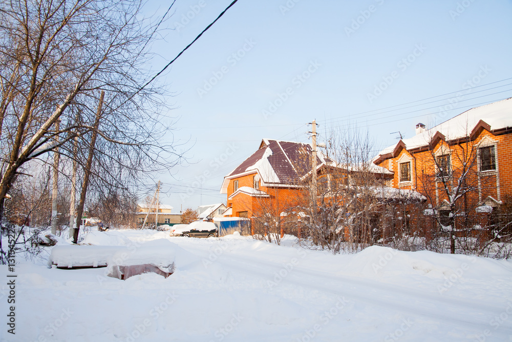 Winter rural landscape with brick cottages