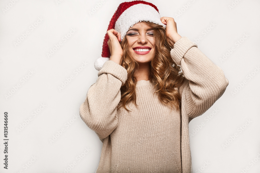 Beautiful positive blonde in a sweater and festive cap Beautiful positive blonde in a sweater and festive cap