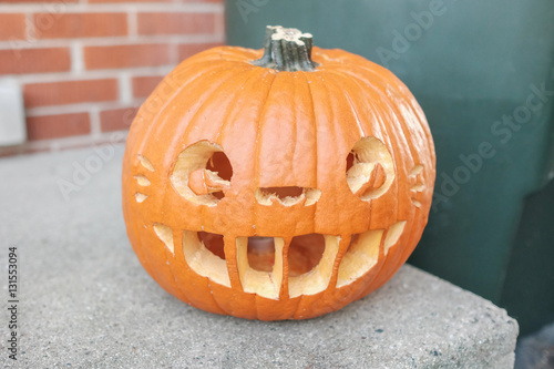 Orange pumpkin Halloween pumpkin head jack lantern in the front door 