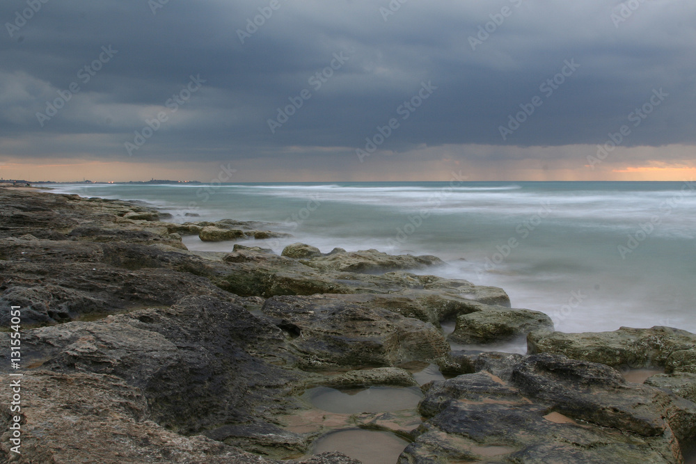 Sunset in Automn on the beach rocks long exposure Sunset in Automn on the beach rocks long exposure