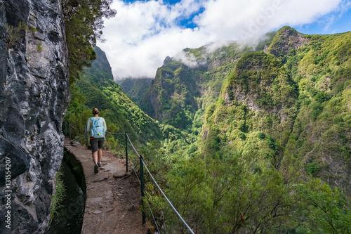 Woman traveler at Madeira mountain hiking path.