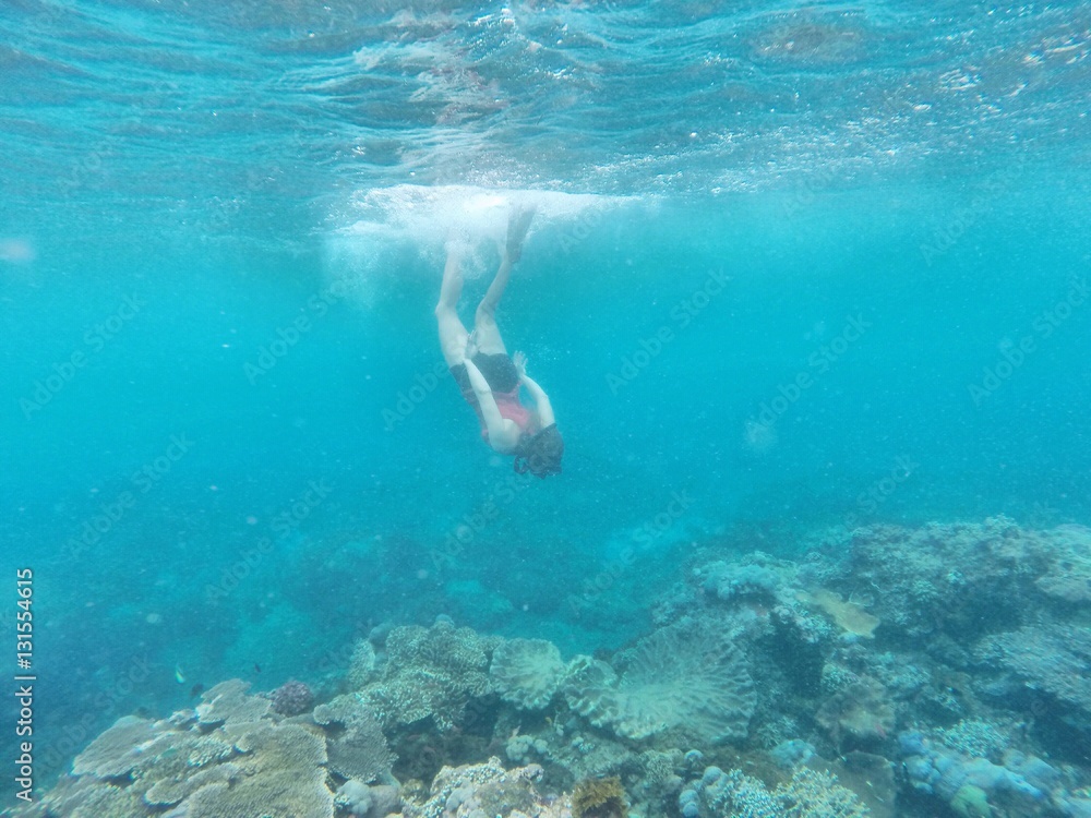 Snorkeler diving under