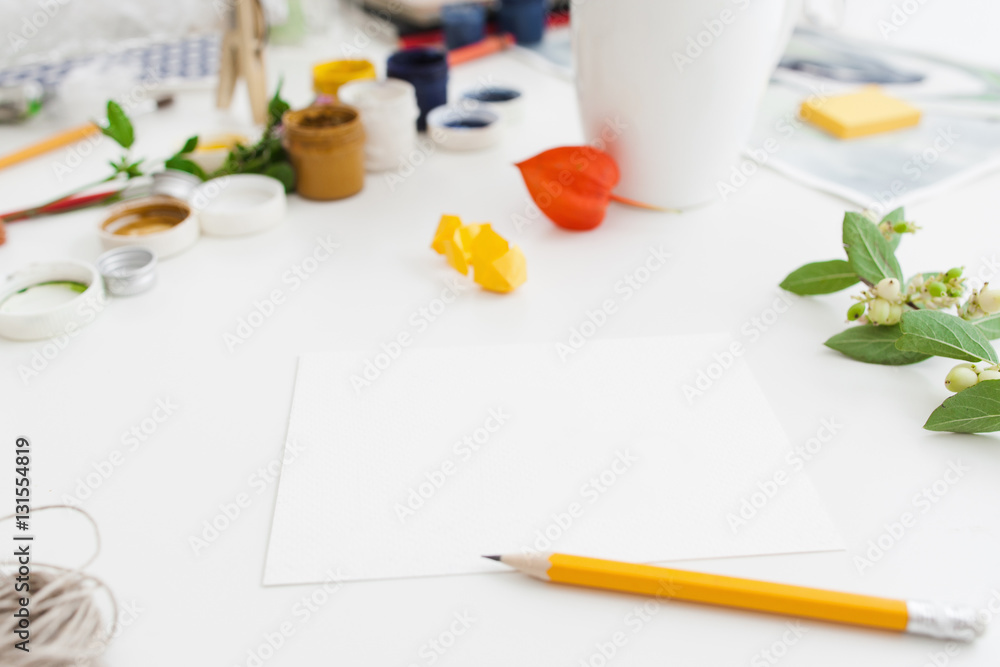 Messy Instruments Messy artist workplace with tools, free space. White table with blank ...