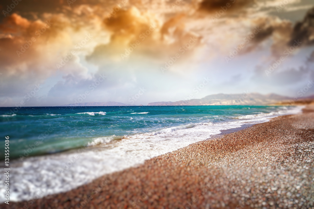 Obraz premium Tilt shift, beautiful colorful sunset on the sea shore.