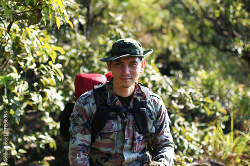 Man Traveler with backpack trekking in forest, Hikers trekking with backpacks in forest 