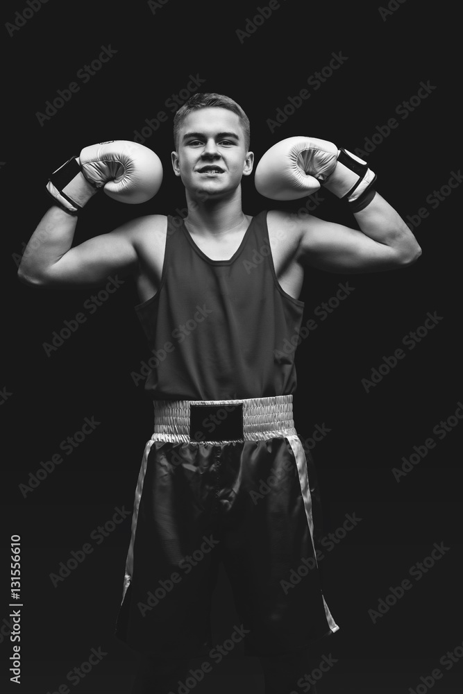 Young boxer sportsman on black background