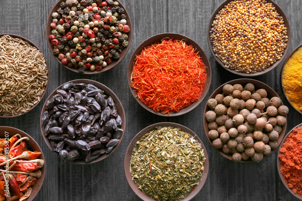 Different spices in bowls on table