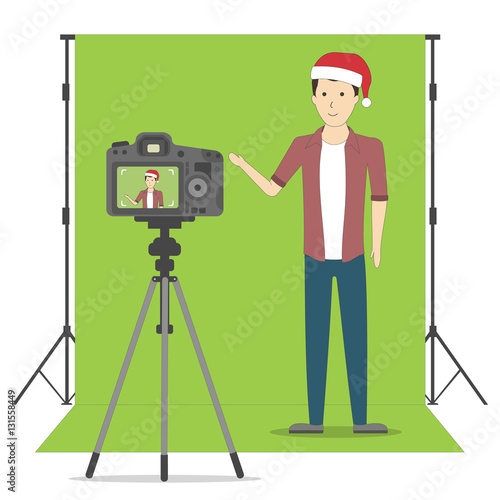 Christmas blog recording on chroma key background. Vlog. Video recording. Handsome boy in santa hat.