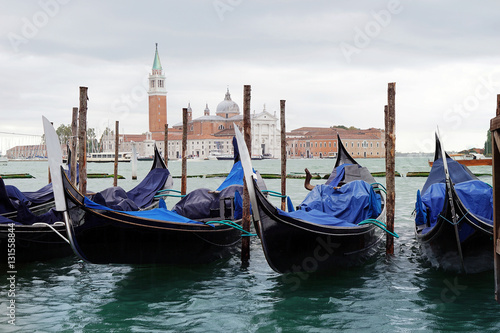 Gondolas moored in canal of Venice
