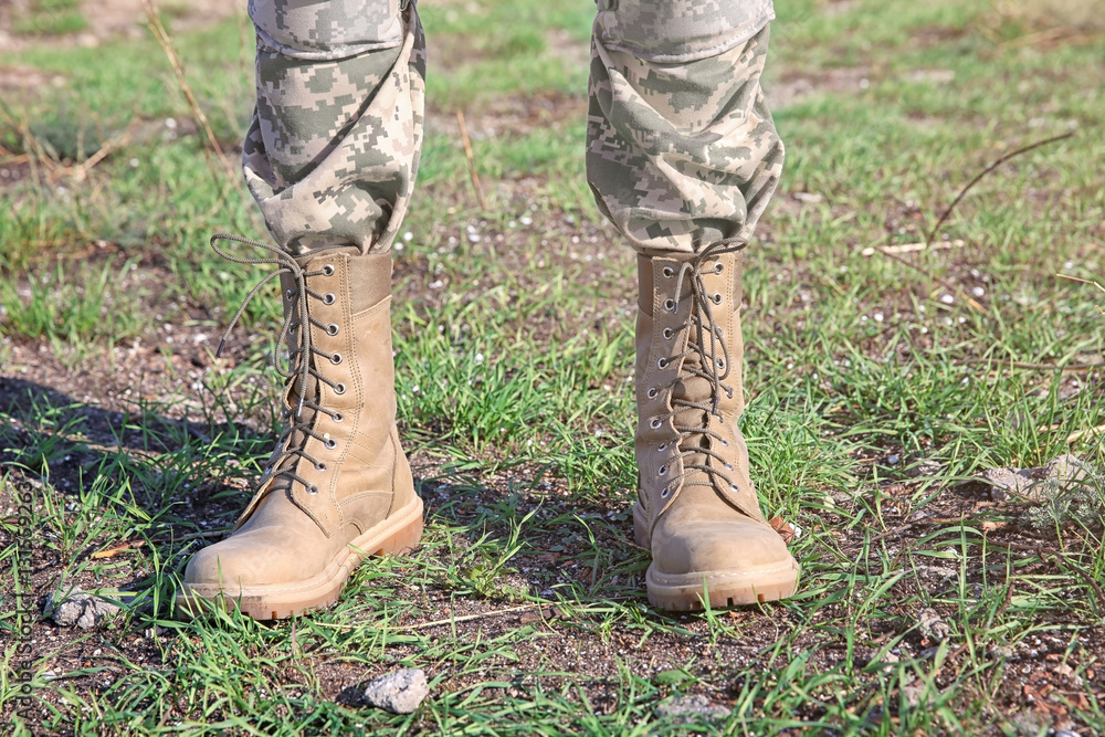 Feet of soldier standing at military firing range, close up view Feet of soldier standing at military firing range, close up view