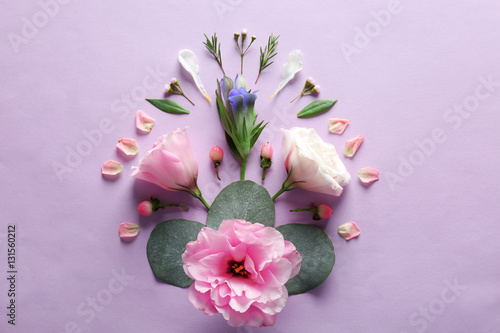 Composition of flowers and leaves on color background