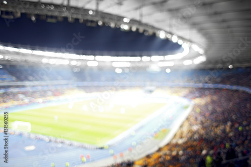 Panoramic view of modern stadium during football match, blurred background © Africa Studio