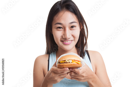 Beautiful Asian healthy girl enjoy eating  hamburger.