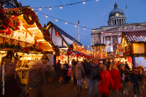 Families enjoying Nottingham Christmas Market in the evening.