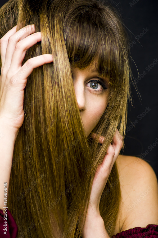 Obraz premium Beauty Woman Portrait with her face half covered by her hair ov