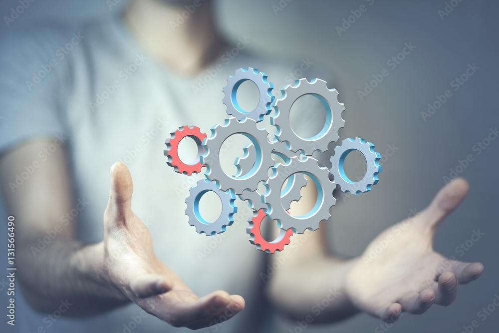 Close up of businessman holding gears in palms Close up of businessman holding gears in palms