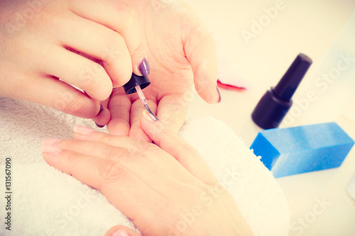 Close up of client and manicurist hands.