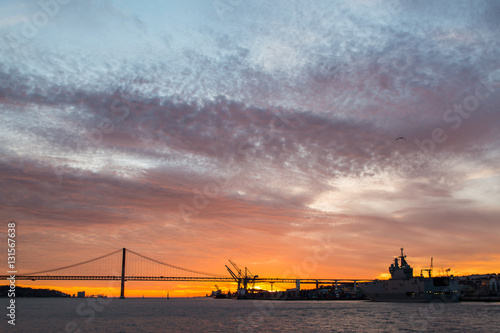 Panoramic views of the Tagus River, Bridge April 25 Lisbon and port at sunset from ship, Portugal.