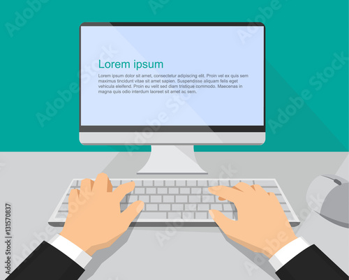 Hands on the keyboard and computer monitor
