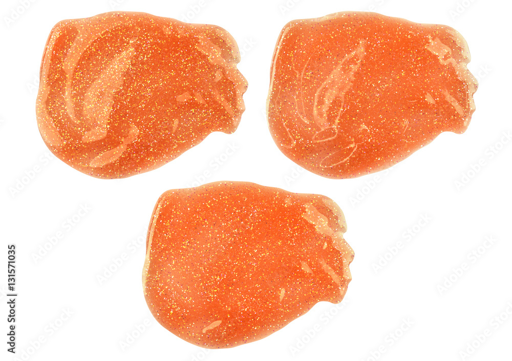 Three orange smeared lip gloss samples with different lighting and reflections, isolated on white background, clipping paths included Three orange smeared lip gloss samples with different lighting and reflections, isolated on white background, clipping paths included